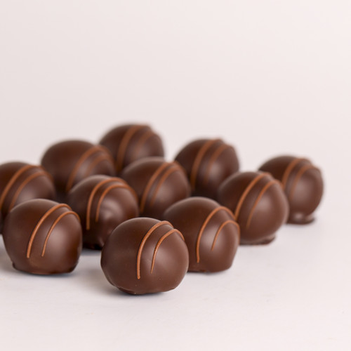 Handmade dark chocolate Bourbon Truffles finished with fine milk chocolate stripes.