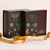 Makana Confections Bourbon Truffles 130 grams and Moa Stout Brittle 395 grams boxes displayed side by side with a branded copper ribbon laid out tastefully in front.