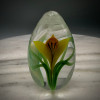 Yellow Crocus Egg closeup,  with slender torchwork green variegated leaves made by glass artisan Chris Sherwin in his glassblowing studio in Bellows Falls, Vermont; this weight showcases a batutto cutting by James Poore of Cape Cod, MA