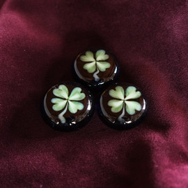 Good Luck "pocketweight"; small glass hand sculpted paperweight, about 1" in dia, made to carry around with you to inspire positive thinking & healing; available on other color backgrounds upon request.