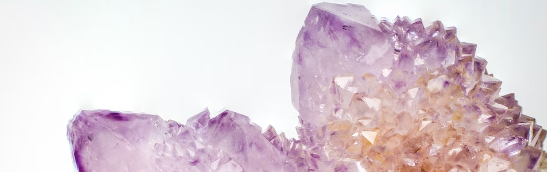 Purple tinted crystals on white background