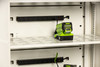 Phoenix Battery Safe – close-up of internal outlets and a green lithium-ion battery charger connected