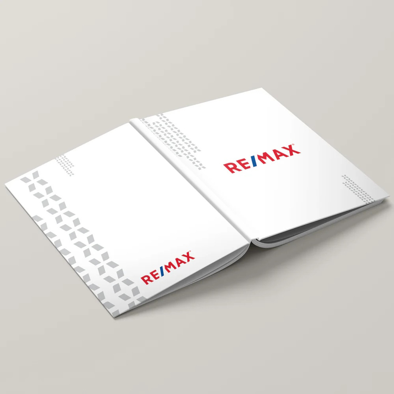 RE/MAX White Dawn hardcover presentation cover – lay-flat binding with backside view of soft-touch finish and branded design