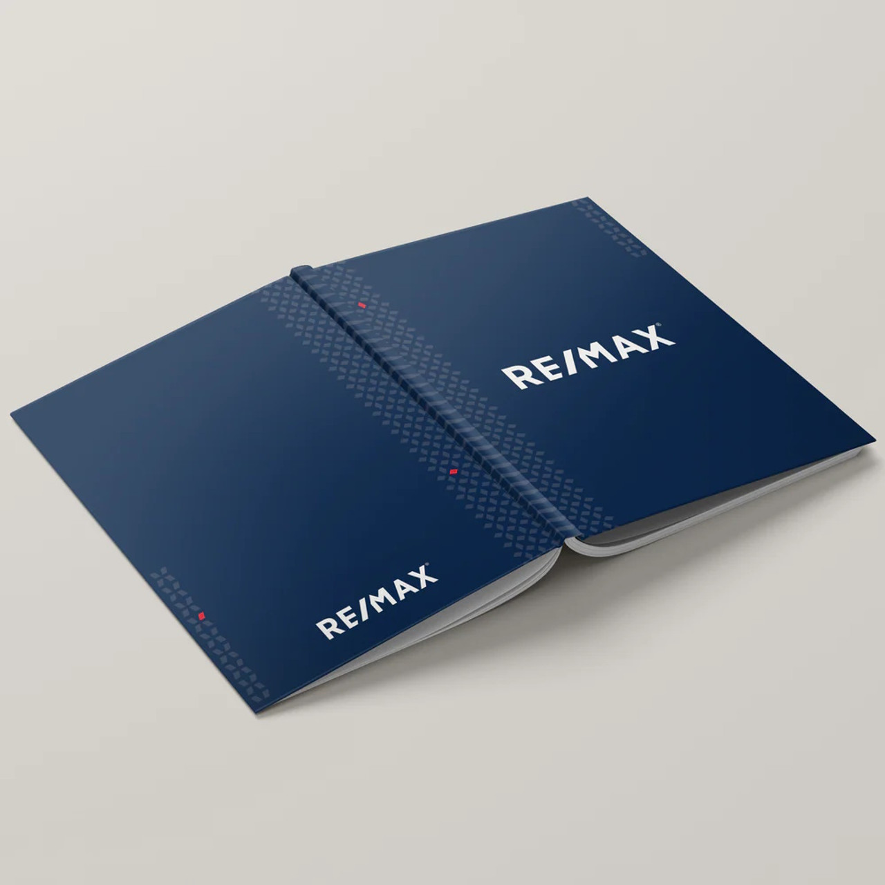 RE/MAX Dsuk Blue hardcover presentation cover – lay-flat binding with backside view of soft-touch finish and branded design