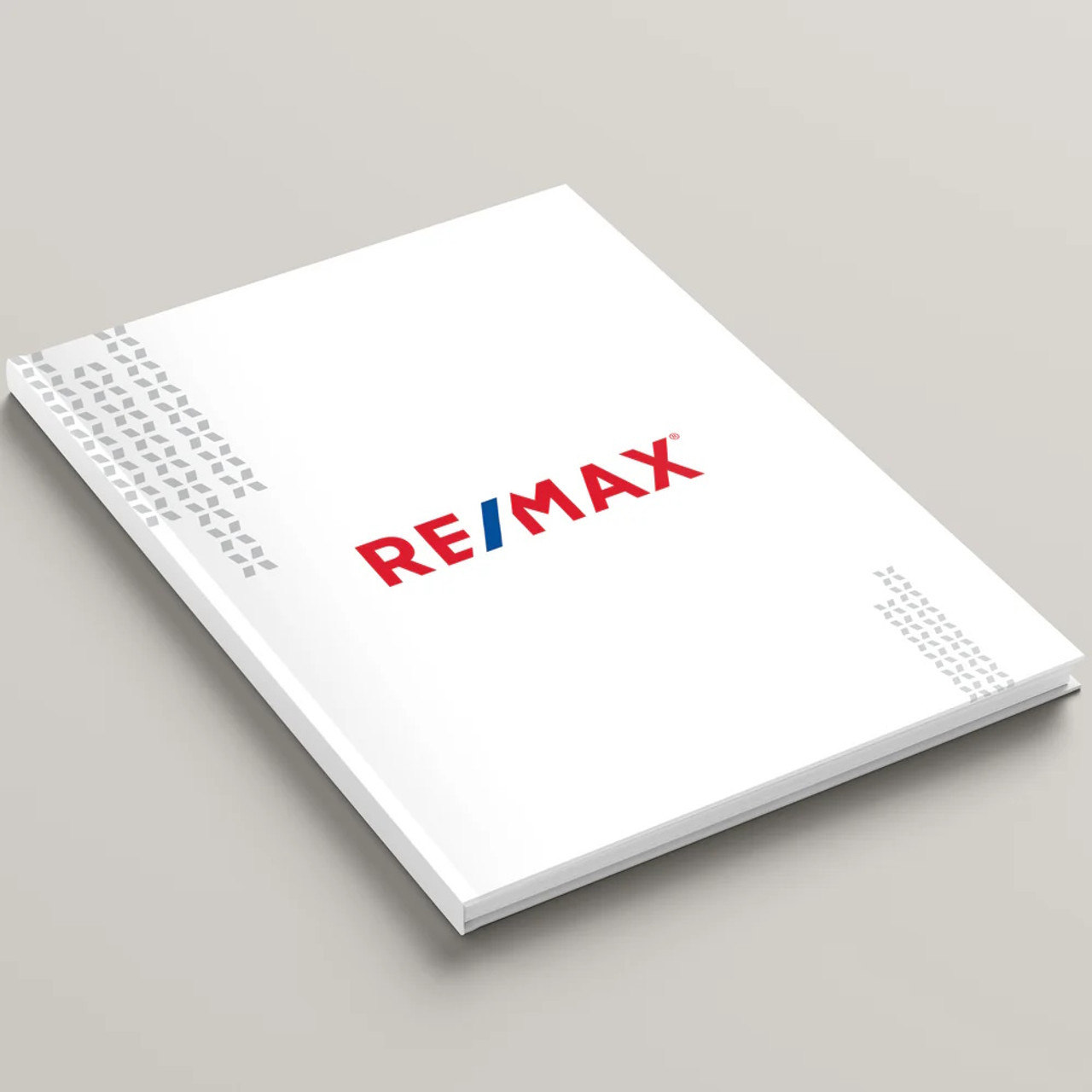 RE/MAX White Dawn hardcover presentation cover – front angled view, white soft-touch finish with modern RE/MAX logo
