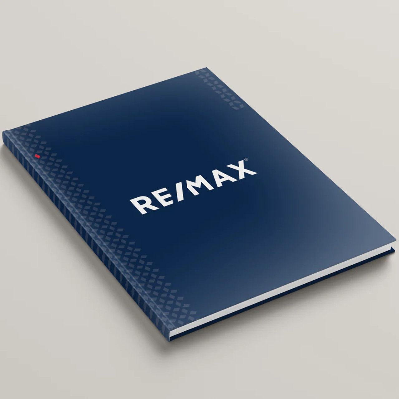 RE/MAX Dusk Blue hardcover presentation cover – front angled view, white soft-touch finish with modern RE/MAX logo