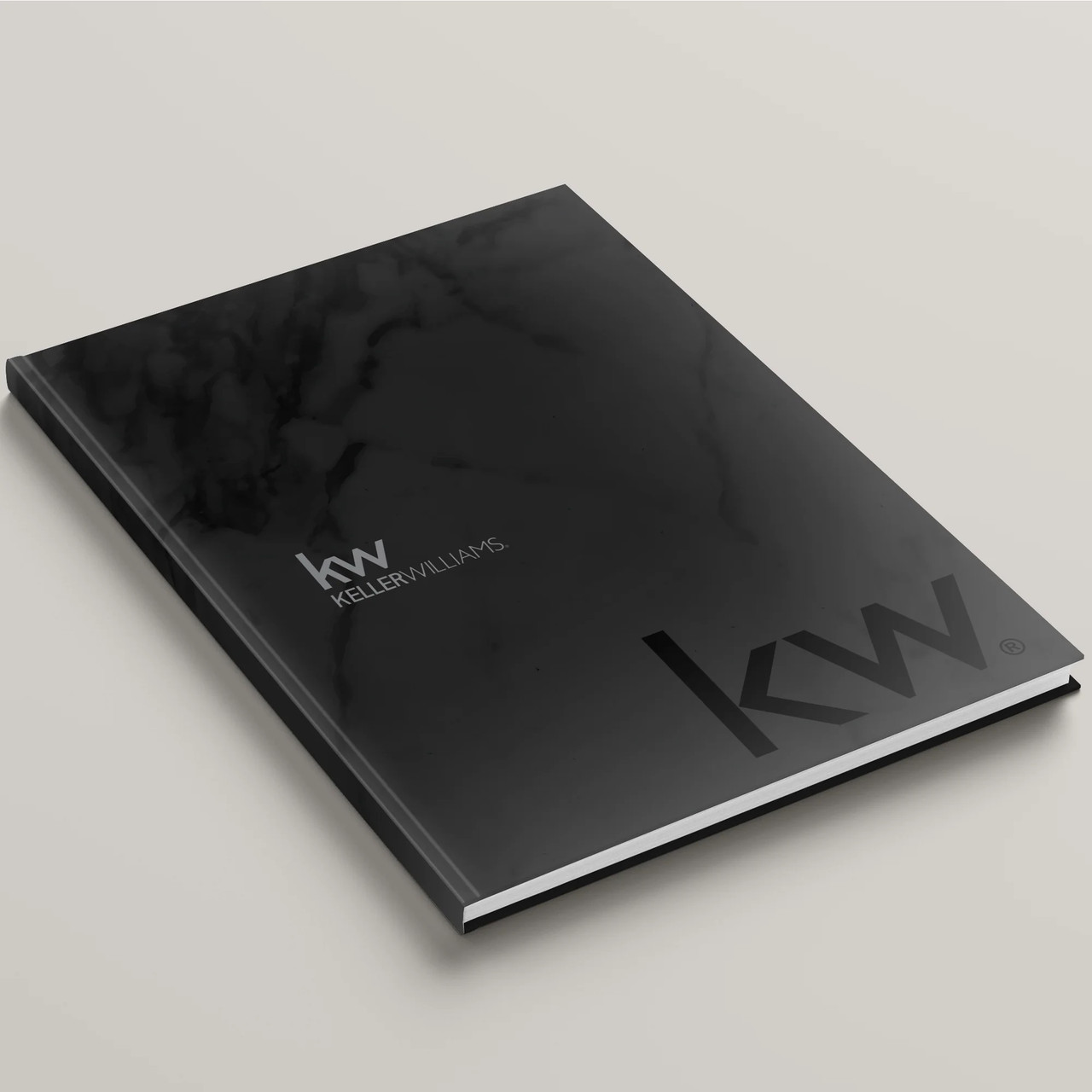 Keller Williams 'Black Marble' hardcover presentation cover – front angled view, white soft-touch finish with modern KW logo