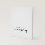 Keller Williams Luxury white lay-flat hardcover presentation cover with black branding.