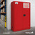 Red FireKing combustible-liquids safety cabinet with double doors and a keyed paddle handle in a warehouse.