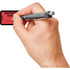 Hand writing on red Tabbies deposition exhibit label with pen, self-adhesive legal exhibit sticker