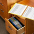 Smead Poly File Box with black wave pattern holding colorful hanging file folders inside a wooden filing cabinet drawer