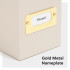 Gold metal nameplate on the side of the beige linen file box with paper label inserted