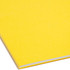 Side edge of yellow Smead legal fastener file folder showing the scored spine for 3/4 inch expansion.