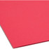 Angled view of the lower corner of a flat red Smead 17740 legal size fastener file folder, highlighting the smooth 11 pt paper surface.