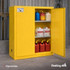 Open yellow FireKing flammable safety cabinet storing labeled liquid containers on adjustable shelves.