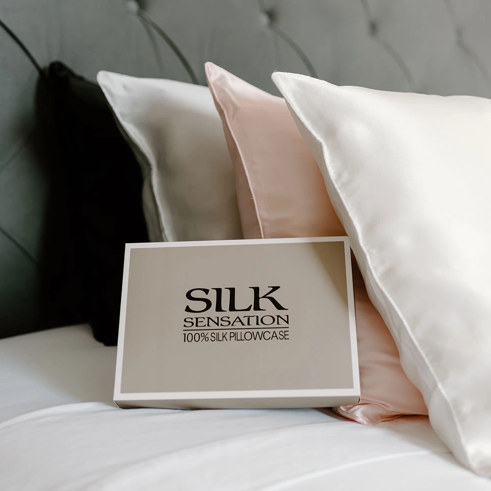 Silk Sensation boxed pillowcase displayed with ivory, pink and silver silk pillowcases