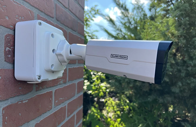 SureVision bullet security camera installed outdoors on a brick wall