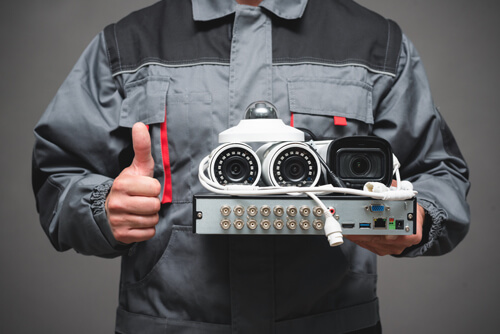 Man holding government approved security cameras