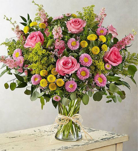Everything comes alive in spring, and our unique new bouquet puts that breezy, natural beauty front and center. Soft, pink and yellow blooms, loosely gathered with lush greenery for an abundance of style and texture. Flowing from a clear glass vase tied with raffia, it’s a gift that delivers the season’s vibrant landscape in every last detail.