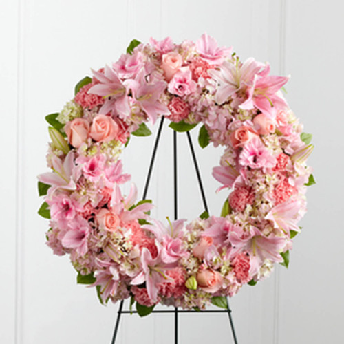 The Loving Remembrance™ Wreath is a blushing display of grace and beauty to honor the life of the deceased at their final tribute. Pink roses, Oriental lilies, gladiolus, hydrangea and carnations are brought together with lush greens to form the shape of a wreath, offering warmth and comfort with its sweetly sophisticated elegance.