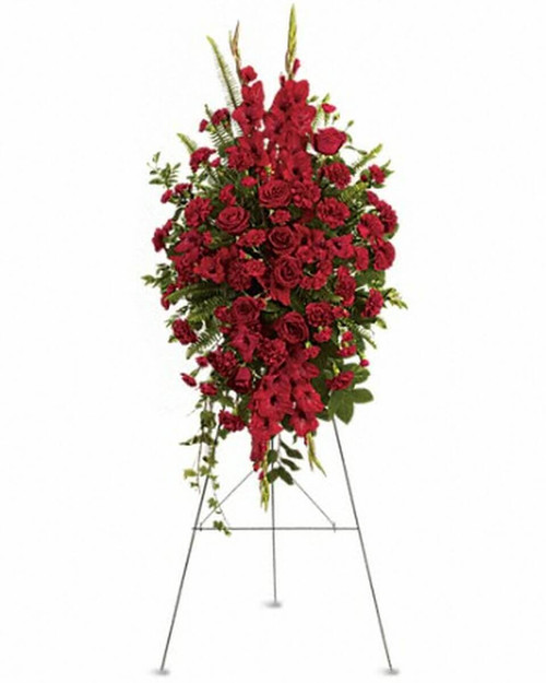 The radiant arrangement includes red roses, red gladioli, red carnations and red miniature carnations, accented with assorted greenery.