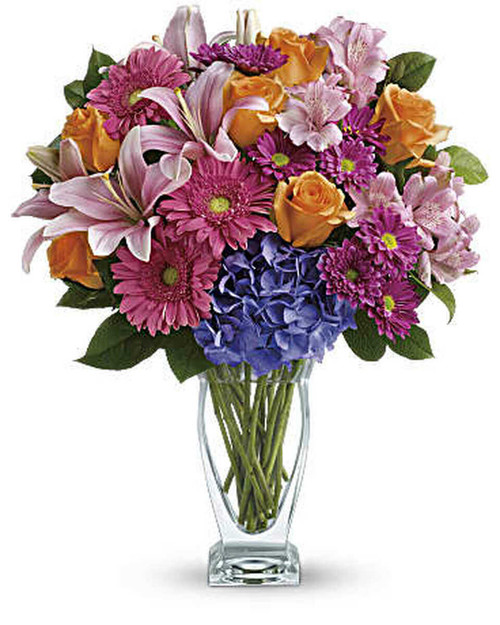 This versatile mix includes blue hydrangea, orange roses, light pink asiatic lilies, pink alstroemeria, hot pink gerberas and purple daisies with a bit of rich green salal.
Delivered in Teleflora's gorgeous Couture Vase.
Orientation: All-Around