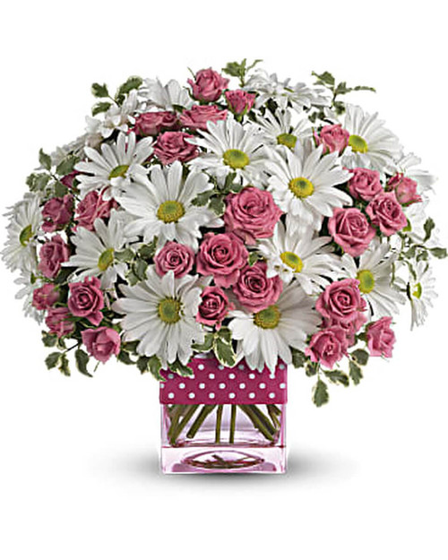 Crisp white daisies and hot pink roses are delivered in a pink glass cube vase that's adorned with a polka dot print ribbon.
Orientation: All-Around