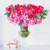 This stunning design is reminiscent of the floating feeling of love. 50 classic red roses are raised above a cloud of hot pink hydrangea, delicate cymbidium orchids, and tufts of whimsical greenery. This majestic arrangement floats atop a 19" tall glass pedestal and stands at an impressive 30" tall and 27" wide overall.