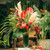 Exotic floral arrangement. Palm leaves and pampas grass are seen supporting the pink Protea and Coxcomb blooms.  Amaranthus peeks through the green fern.  Banana leaves line the interior of the 18" tall glass vase.  Arrangement stands at approximately 26" tall.