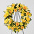 Ring of Friendship™ Wreath holds golden yellow roses, Asiatic lilies and dendrobium orchids against a background of assorted greenery. 