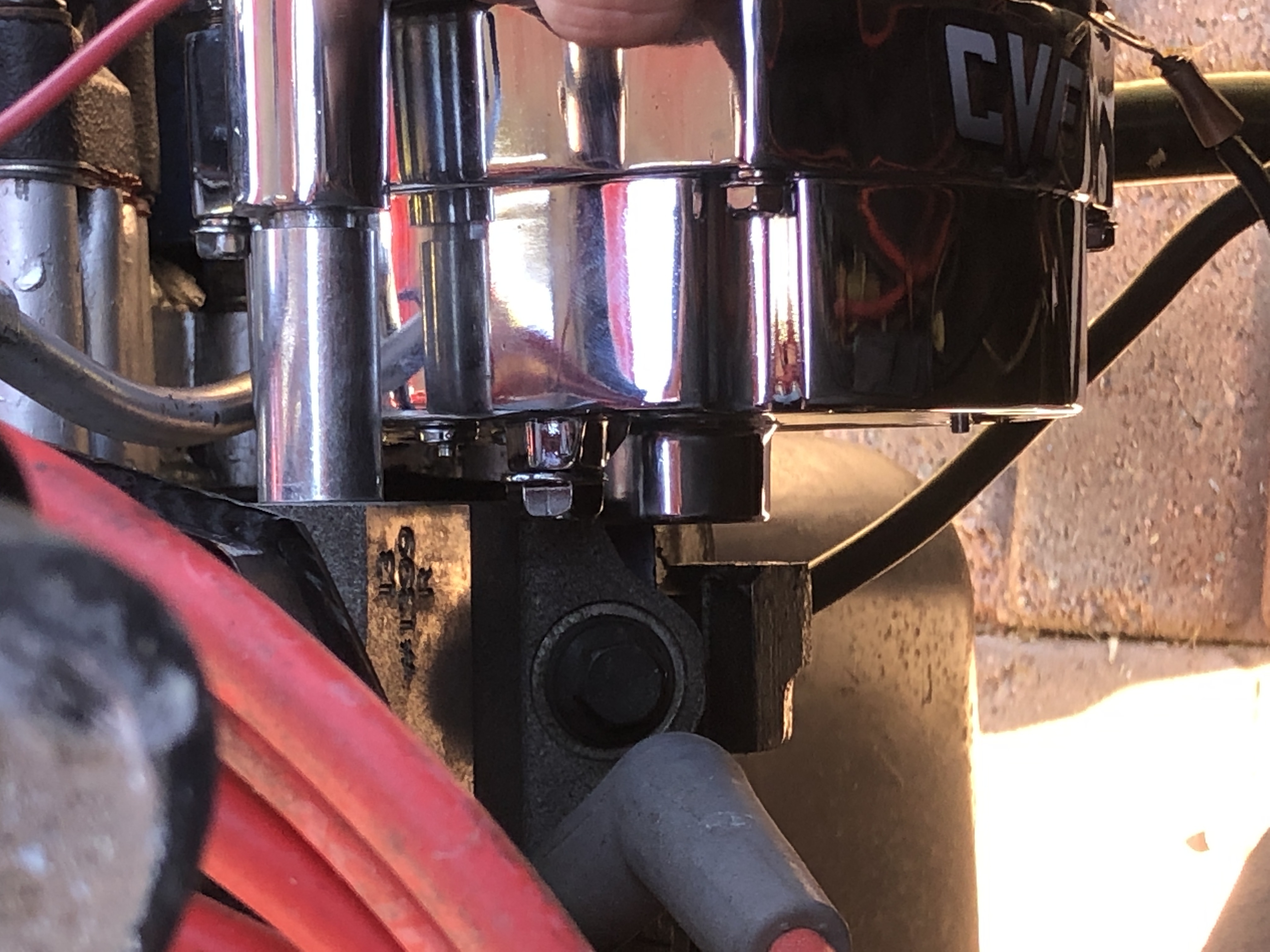 An alternator power lug on the rear of the case contacting the engine, showing why the case needs clocking