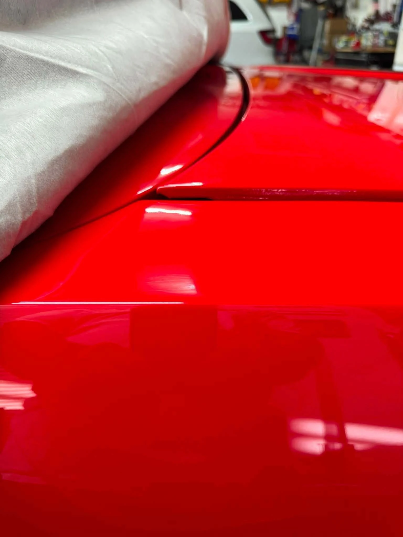 The rear edge of a hood standing proud of the cowl, the symptom this article covers