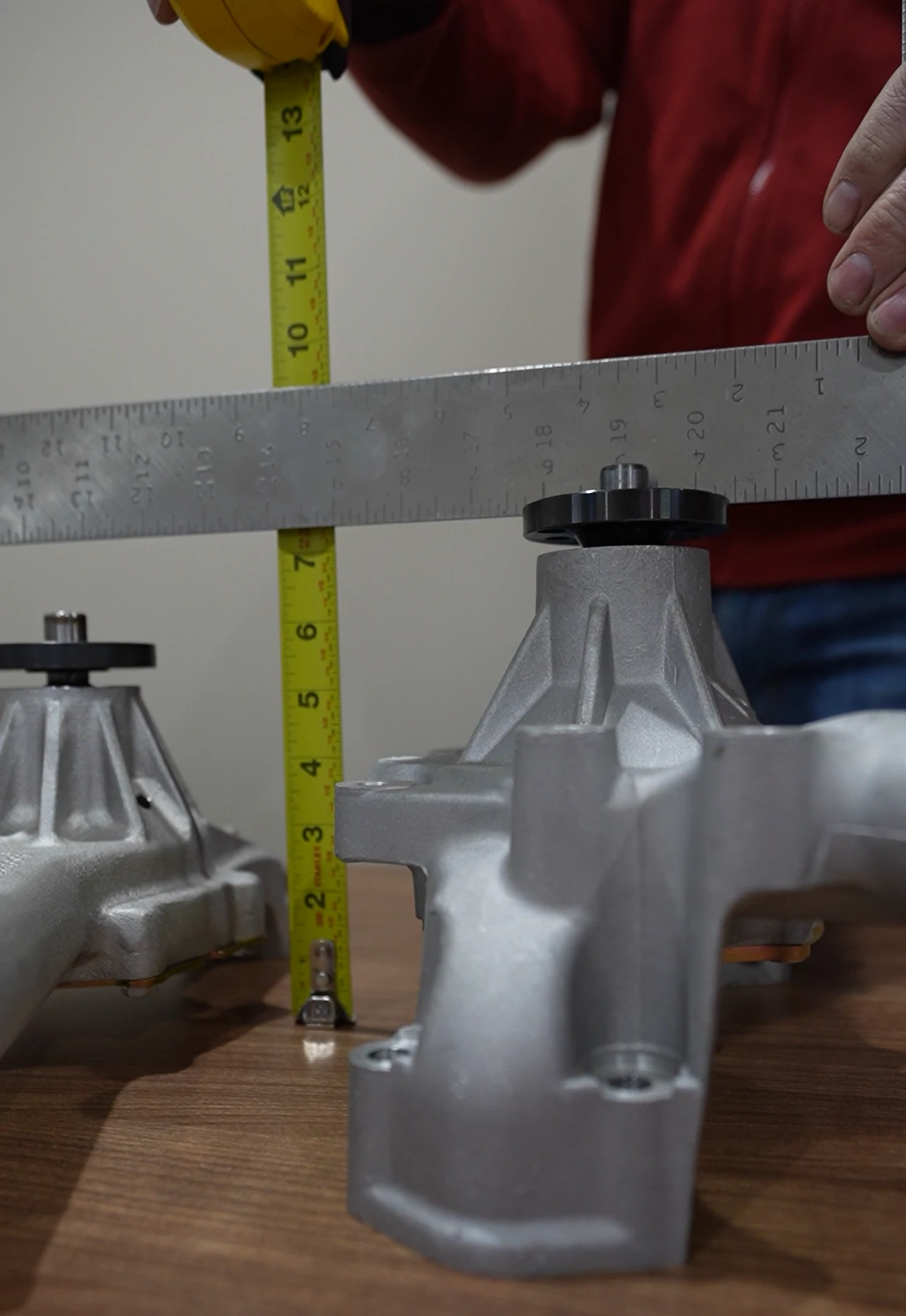 Measuring water pump height on a bench with a straight edge and tape measure
