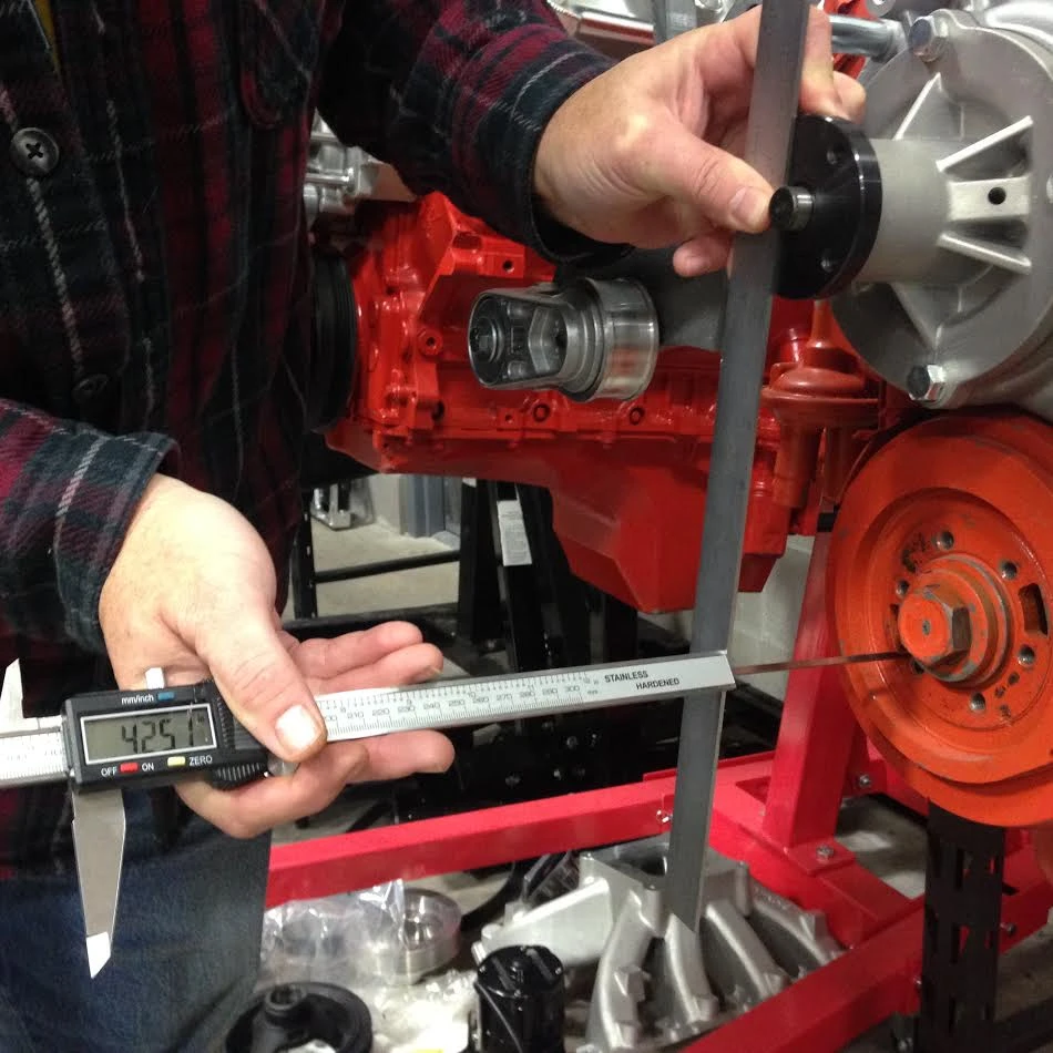 Measuring the horizontal distance between the water pump and balancer pulley mounting surfaces