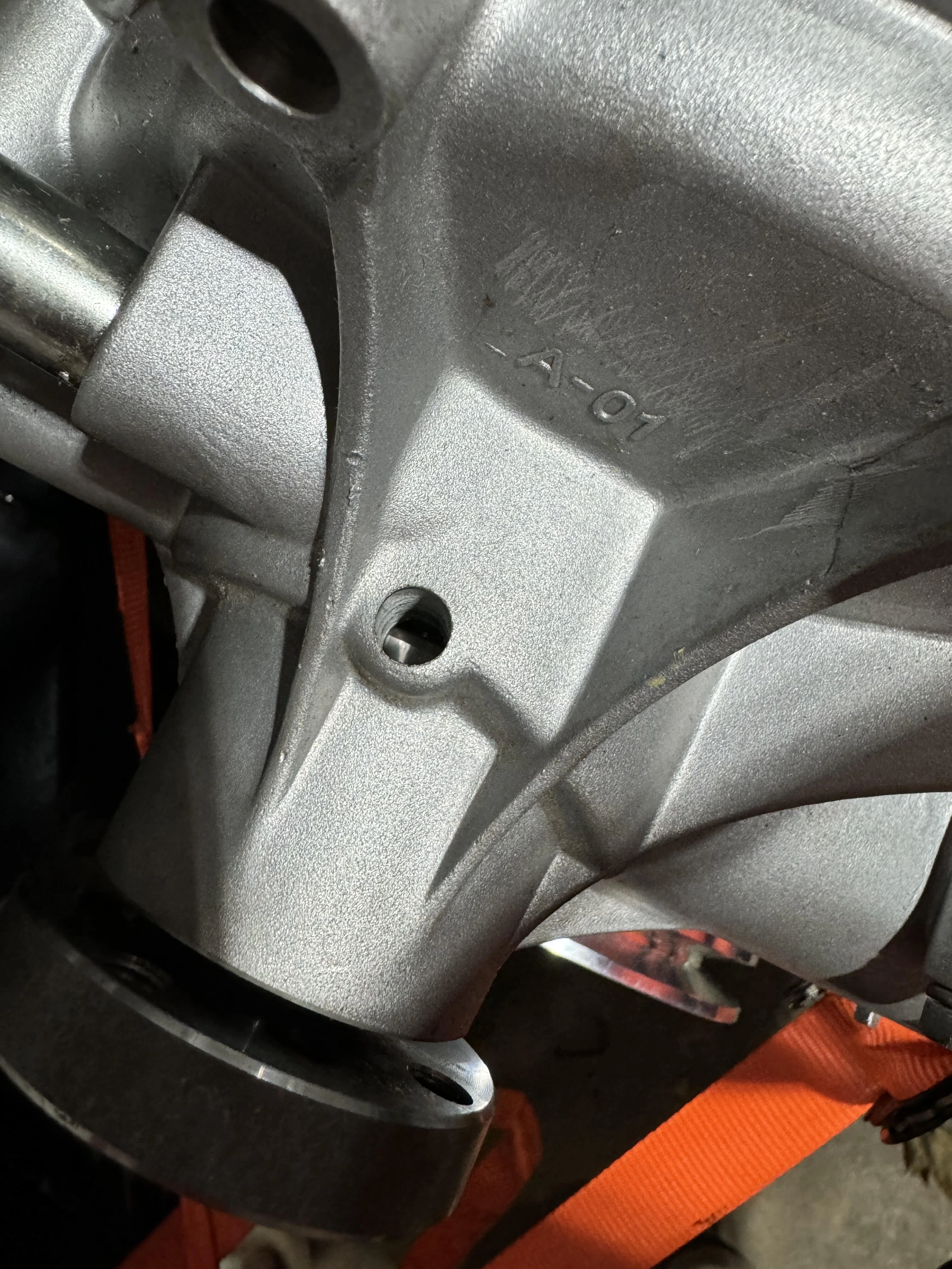 The weep hole on a CVF water pump casting, below the shaft