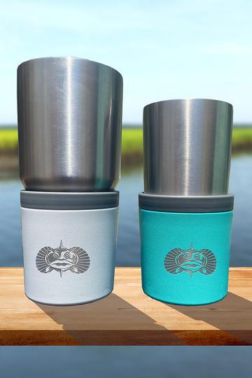 TOADFISH Toadfish Anchor Beverage Holder, stainless steel tankard with colorful neoprene sleeve featuring a towel branding and anchor logo, placed outdoors on a wooden surface.