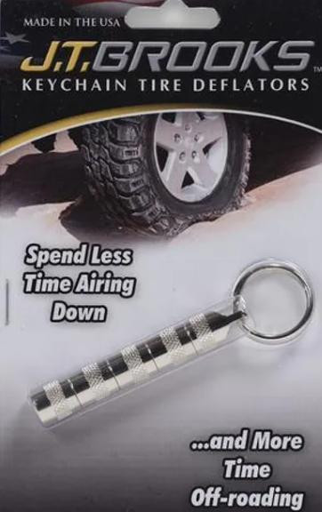 J.T. Brooks J.T.Brooks Automatic Tire Deflators, keychain tire deflator with a textured grip, displayed on packaging with an off-road tire in the background.