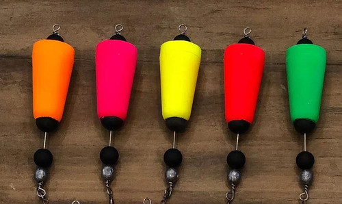 FOUR HORSEMEN Four Horsemen Tackle Popper, colorful fishing lure with bright orange, pink, yellow, red, and green bodies on a wooden surface.