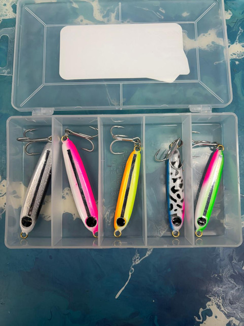 ES LURES ES Lures Tackle Box - 1.25 & 2 oz, clear plastic tackle box with five colorful fishing lures inside, including pink, yellow, silver, and patterned designs.