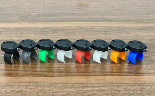 REEL GLO Reel Glo Reel Illuminator, set of vibrating clip lights in black, silver, green, white, red, yellow, and blue colors on wooden surface.
