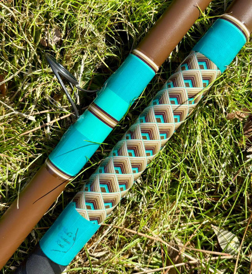 NICK'S CUSTOM RODS 2026 Nick's Custom Rods - CTS 1205 Conventional fishing rod, resting on grass with colorful patterned grip and turquoise accents.