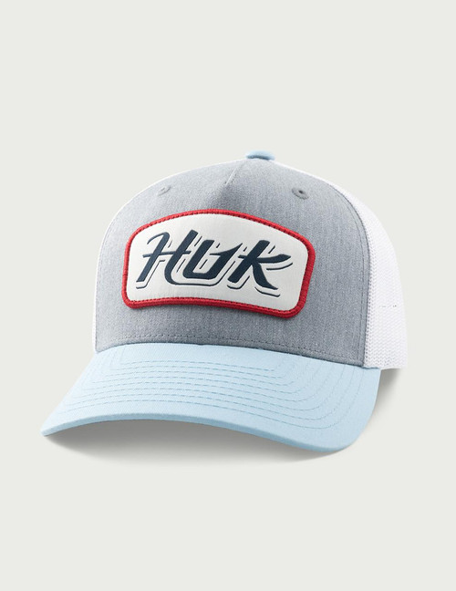 HUK Youth Script Trucker, light blue and white baseball cap with a gray front panel and red and black embroidered logo patch.