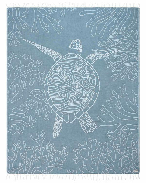 Sand Cloud Beach Towels, light blue towel featuring a white outline of a turtle swimming among coral reefs.