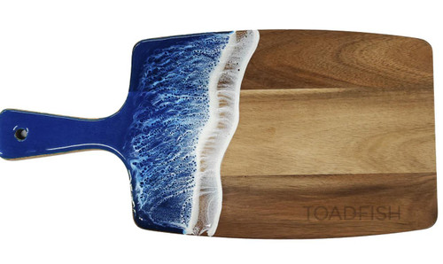 Toadfish Wooden Coastal Serving Board, wooden serving board with a blue resin ocean wave design on one side.