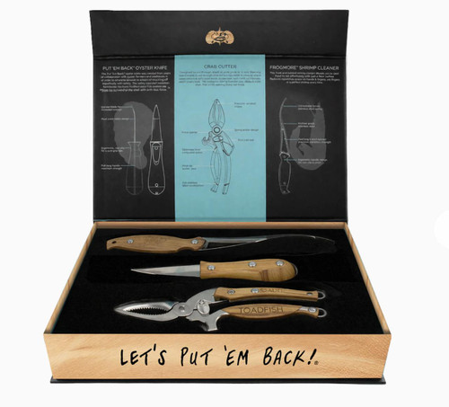 Toadfish Olive Wood Coastal Kitchen Collection, oyster and shrimp cleaning tools set in a wooden box with black foam interior and detailed instructional graphics inside the lid.