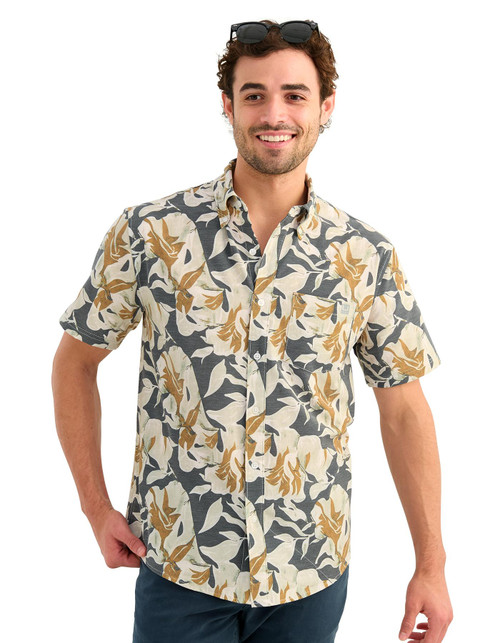 HUK Kona Printed SS Shirt, men's short-sleeve button-up shirt with an allover cream, charcoal, and tan tropical print, modeled against a white background.