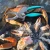 Toadfish Crab Claw Cutter, seafood crab claws being cut with the tool on ice with crab legs in the background.