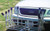 ANGLER'S FISH-N-MATE Surf-Mate 692 10-Rod Cooler Rack, a fish rod holder and cooler rack mounted on a car's front bumper