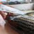 Dexter RUSSELL Dexter Dextreme Dual Edge Fillet Knife, close-up of a person filleting a fish with the dual-edged fillet knife.