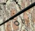 NINJA TACKLE Ninja Tackle 7' Dagger Spinning Rod, close-up of the spinning rod against a tree bark background.